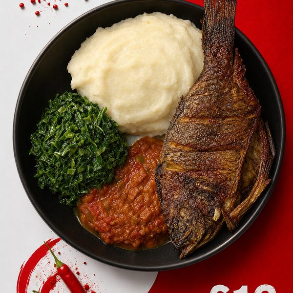 Whole crispy-fried sea bream with isitshwala, muriwo greens and tomato sauce